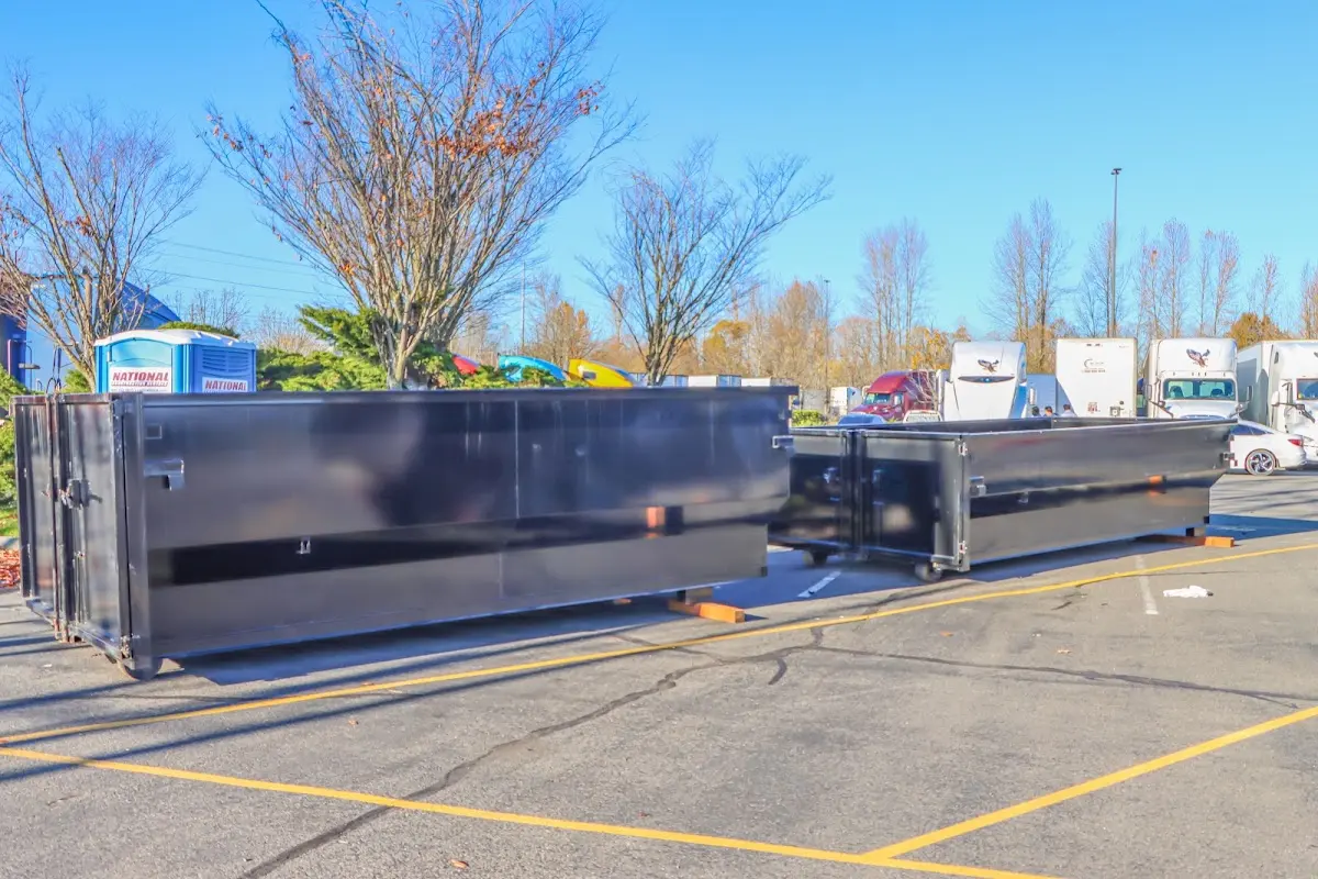 Professional dumpster rental service with roll-off container on residential driveway in Avon Park